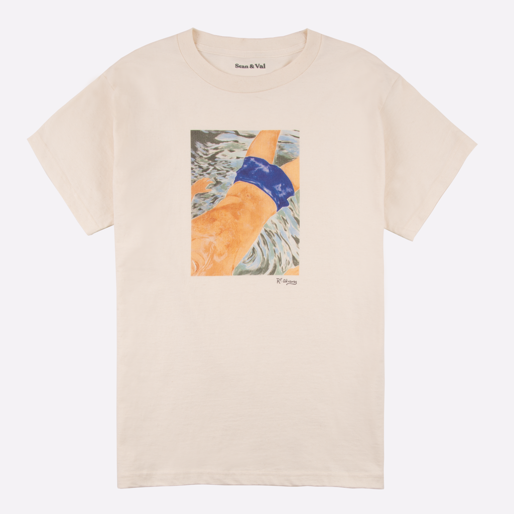 Image of cream colored t-shirt with artwork printed on front. 